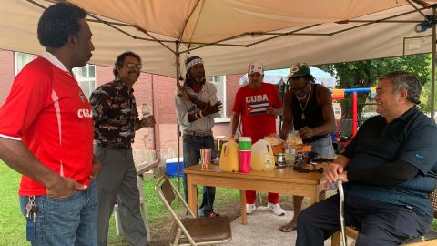 Ernesto Rodriguez, Marcos Calderon, Rodosvaldo Pozo, Osvaldo Fajardo, Norberto Gomez Mendez, and Jose Lores all sharing a meal on a weekday afternoon.