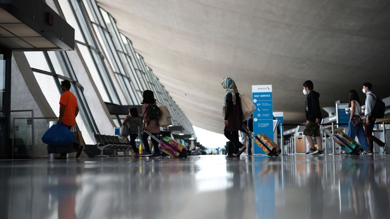 Refugees walk through the departure terminal to a bus at Dulles International Airport after being evacuated from Kabul following the Taliban takeover of Afghanistan on August 31, 2021 in Dulles, Virginia.