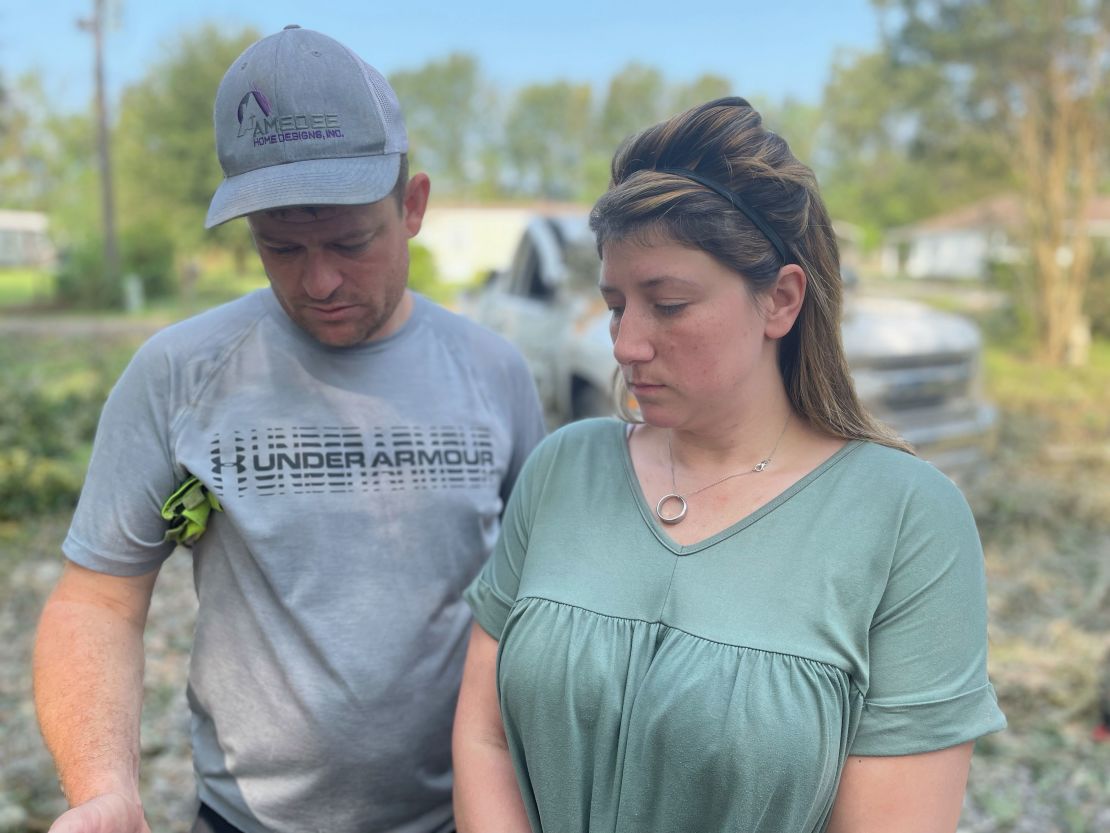 Chasity Fatherree and her husband, Jeremy, stand in the driveway where her father, Dennis Duplessis, was killed Sunday night.