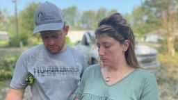 Chasity Fatherree and her husband, Jeremy, stand in the driveway where her father, Dennis Duplessis, was killed Sunday night. A tree crashed down on top of him while Ida rolled into Gonzales, Louisiana, as a Category 3 hurricane.