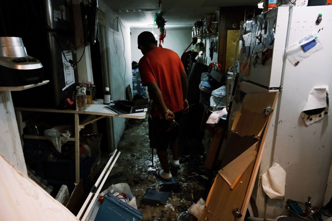 Eddie, an immigrant from Mexico, walks through his flooded basement level apartment in a Queens neighborhood that saw massive flooding and numerous deaths following a night of heavy wind and rain from the remnants of Hurricane Ida on September 3, 2021 in New York City.