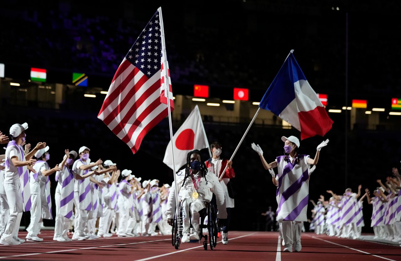 Flag bearers for the United States, Japan and France enter the stadium during the closing ceremony.