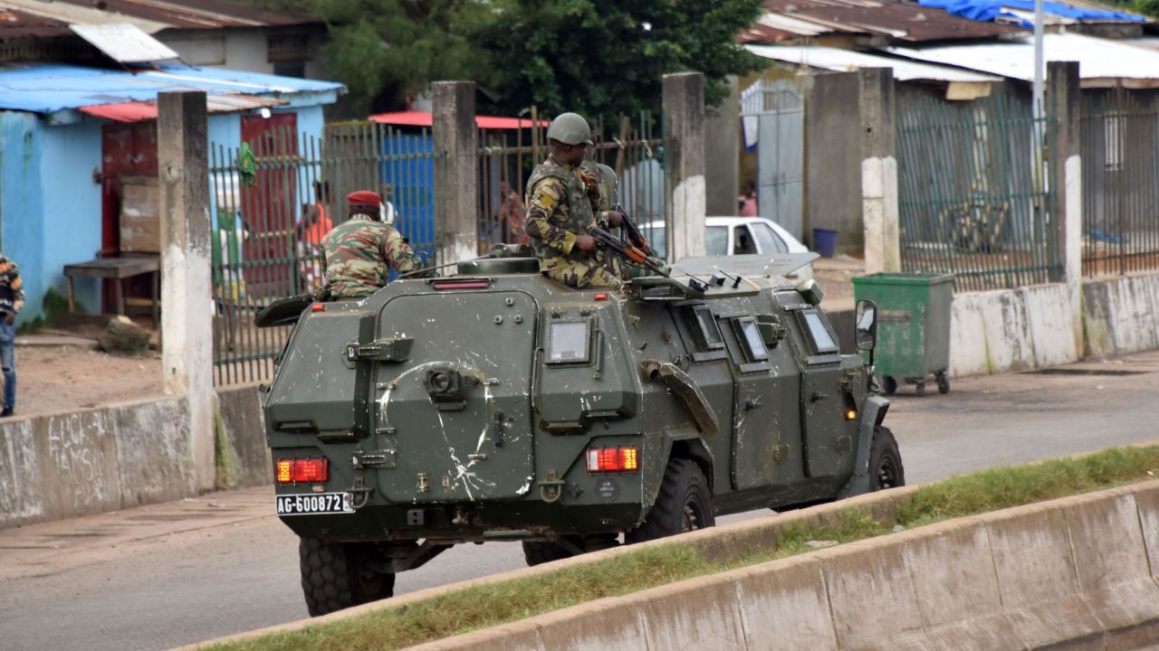 Members of Guinea's armed forces drive through the central neighborhood of Kaloum, in Conakry, on September 5.