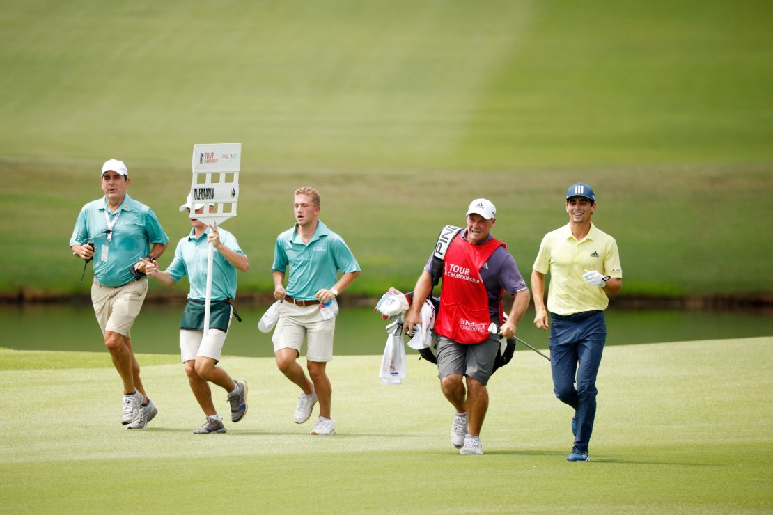 Niemann and caddie Gary Mathews seen jogging on the 18th. The Chilean played his round in one hour, 53 minutes.