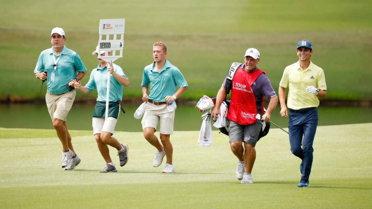 Niemann and caddie Gary Mathews seen jogging on the 18th. The Chilean played his round in one hour, 53 minutes.