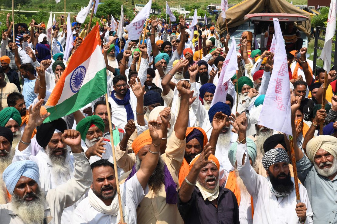 Farmers shout slogans in protest against the government's agricultural reforms, which they say will ruin their livelihood.