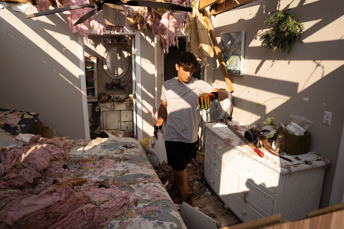Michael Szeplaki helps to clean up his family's vacation house in the wake of Hurricane Ida on Saturday in Grand Isle, Louisiana.