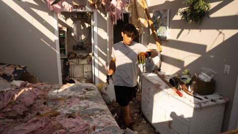 Michael Szeplaki helps to clean up his family's vacation house in the wake of Hurricane Ida on Saturday in Grand Isle, Louisiana.