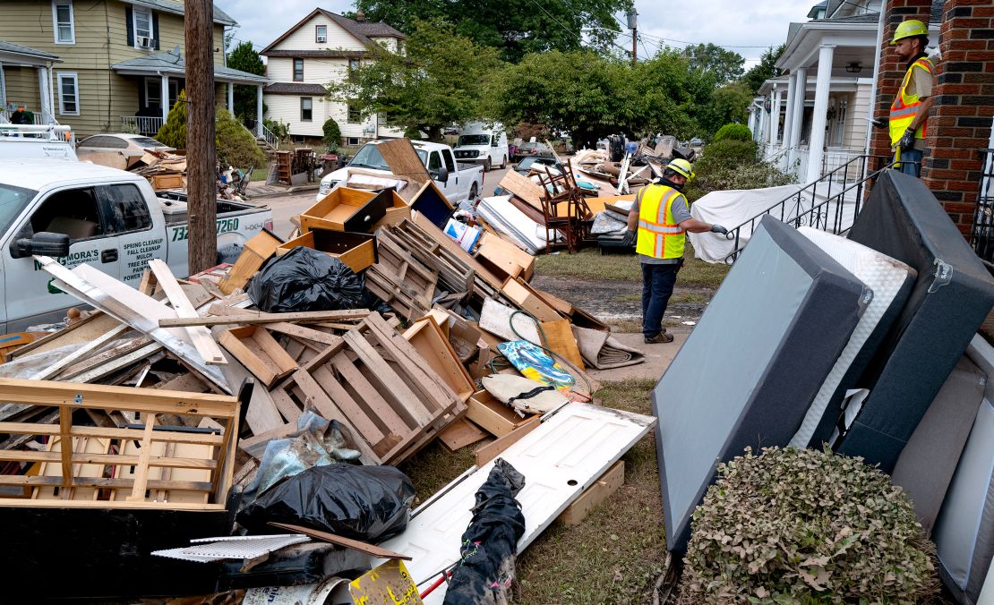 Utility workers work Sunday among debris from flood damage caused by the remnants of Hurricane Ida in Manville, New Jersey.