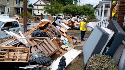 Utility workers work Sunday among debris from flood damage caused by the remnants of Hurricane Ida in Manville, New Jersey.