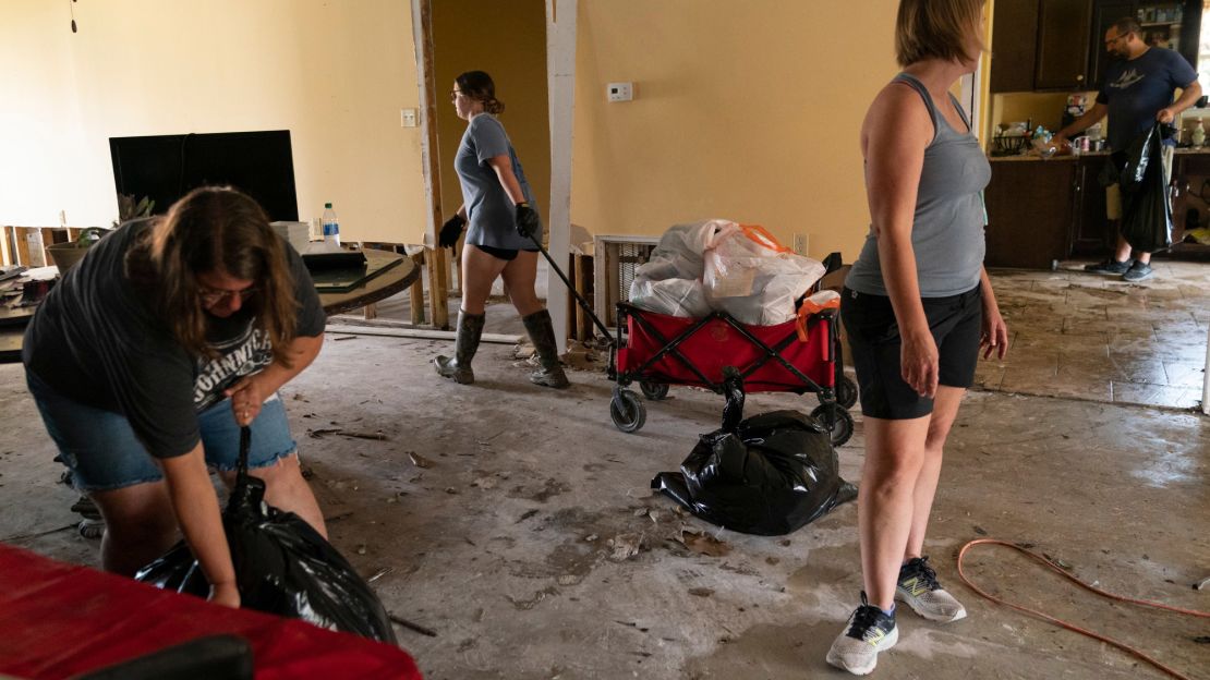 Cassie Falgoust, left, and her sister Michelle Smith, right, help clean out their parents' home.