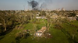 Damage from Hurricane Ida is seen in Norco, Louisiana, as smoke billows from an oil refinery in the distance.