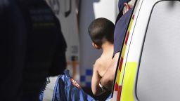 Three-year-old AJ Elfalak is carried by a paramedic into an ambulance after he is found alive on the family property near Putty, north west of Sydney, Australia, Monday, Sept. 6, 2021. AJ was found sitting in a creek and cupping water in his hands to drink three days after he was lost in rugged Australian woodland. (Dean Lewins/AAP Image via AP)