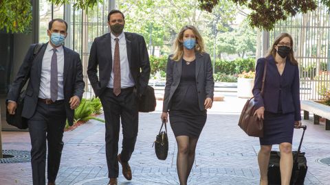 Elizabeth Holmes, founder and former chief executive officer of Theranos Inc. (center right), arrives at U.S. federal court in San Jose, California, U.S., on Thursday May 6, 2021. Holmes and her lawyers appeared in-person in the federal court where the Theranos founder and former chief executive officer was scheduled to go to trial in August on charges that the blood-test startup once valued at $9 billion was a fraud.