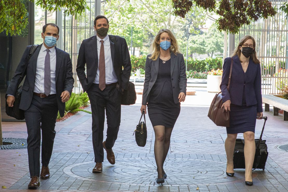 Elizabeth Holmes, founder and former chief executive officer of Theranos Inc. (center right), arrives at U.S. federal court in San Jose, California, U.S., on Thursday May 6, 2021. Holmes and her lawyers appeared in-person in the federal court where the Theranos founder and former chief executive officer was scheduled to go to trial in August on charges that the blood-test startup once valued at $9 billion was a fraud. 