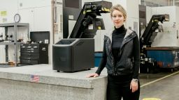 Elizabeth Holmes with a Theranos blood testing machine at the company's facility in Newark, California, in December 2015. 