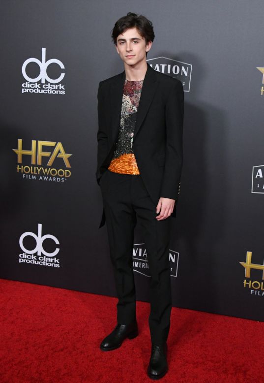 A hallmark of Chalamet's wardrobe is his fondness for sparkle, as demonstrated by the sequined top he wore under a black suit in 2018.