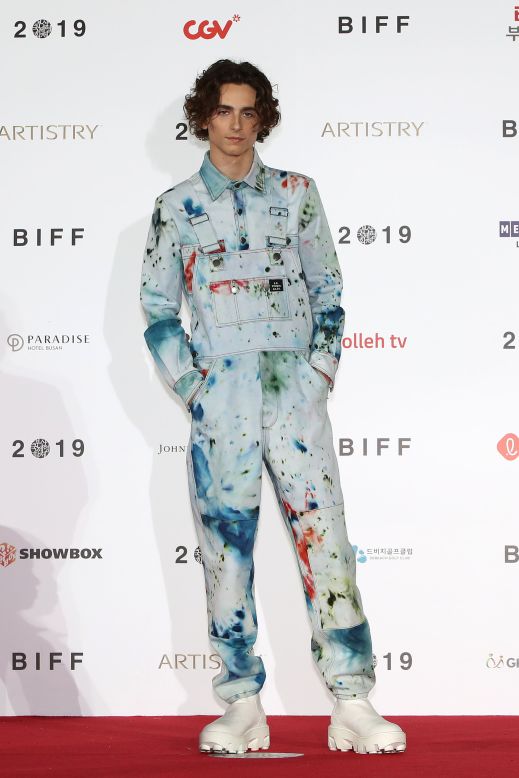 His style has maintained a sense of youthfulness, as seen with the  paint-splattered overalls (by S.R. Studio. LA. CA.) that he wore to a photocall in South Korea in 2019.