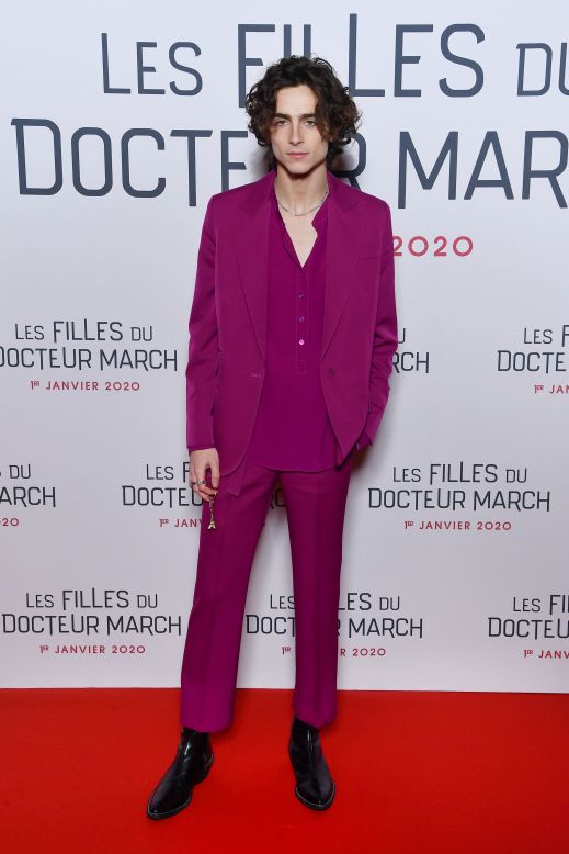 The actor has developed a flair for unexpected accessories such as the Eiffel Tower keychain he carried to the Paris premiere of "Little Women." Pinks were a mainstay of his wardrobe at the movie's other promotional events, as seen with his Stella McCartney suit.