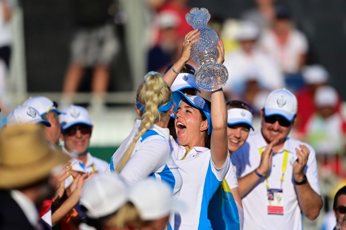Europe's Georgia Hall holds up the trophy after their team win the Solheim Cup.