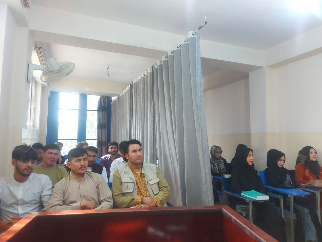 Students divided by a curtain at Avicenna University on Monday.