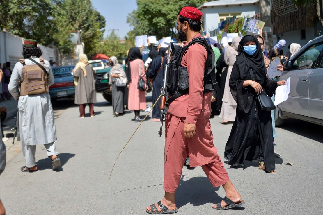 Taliban fighters are seen during the protest on Tuesday. 