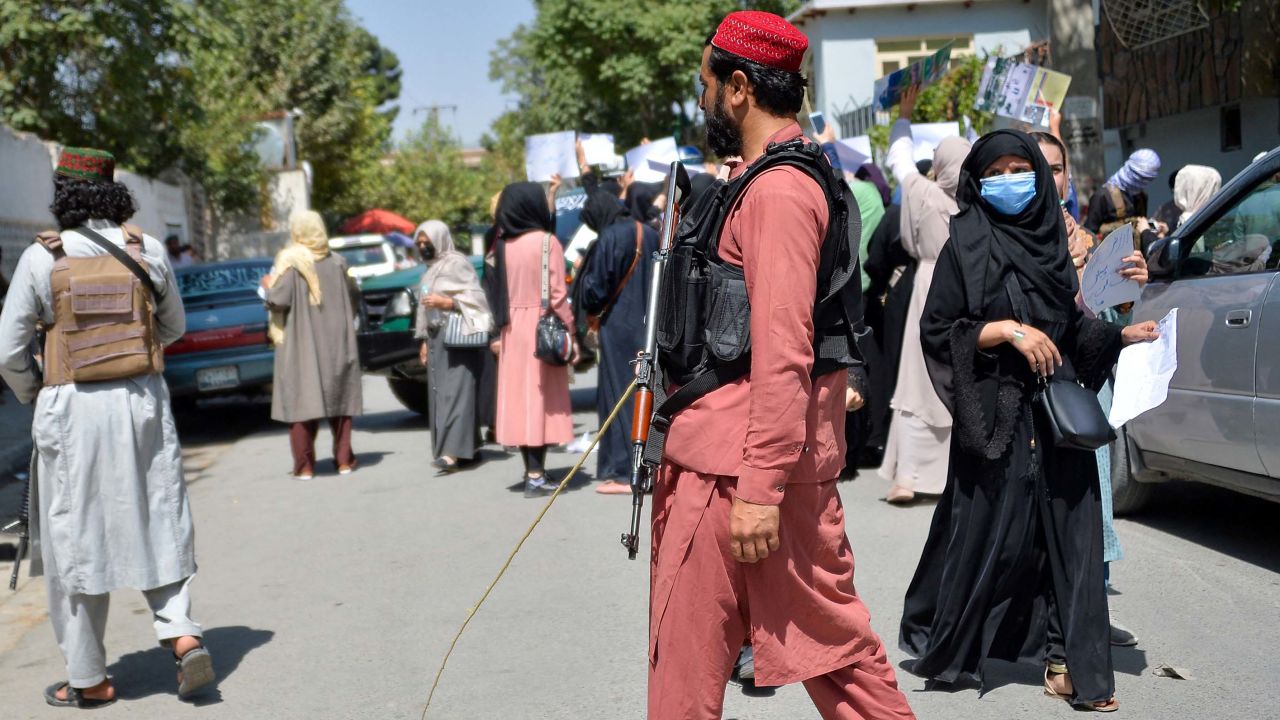 Taliban fighters are seen during the protest on Tuesday.
