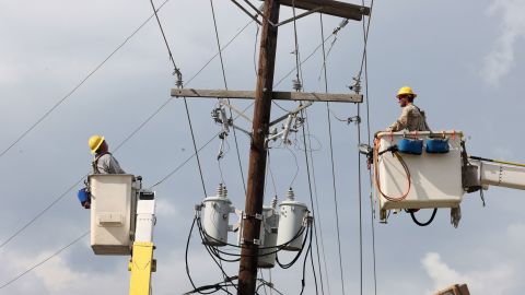 Workers repair power lines in Houma, Louisiana, on August 31. 