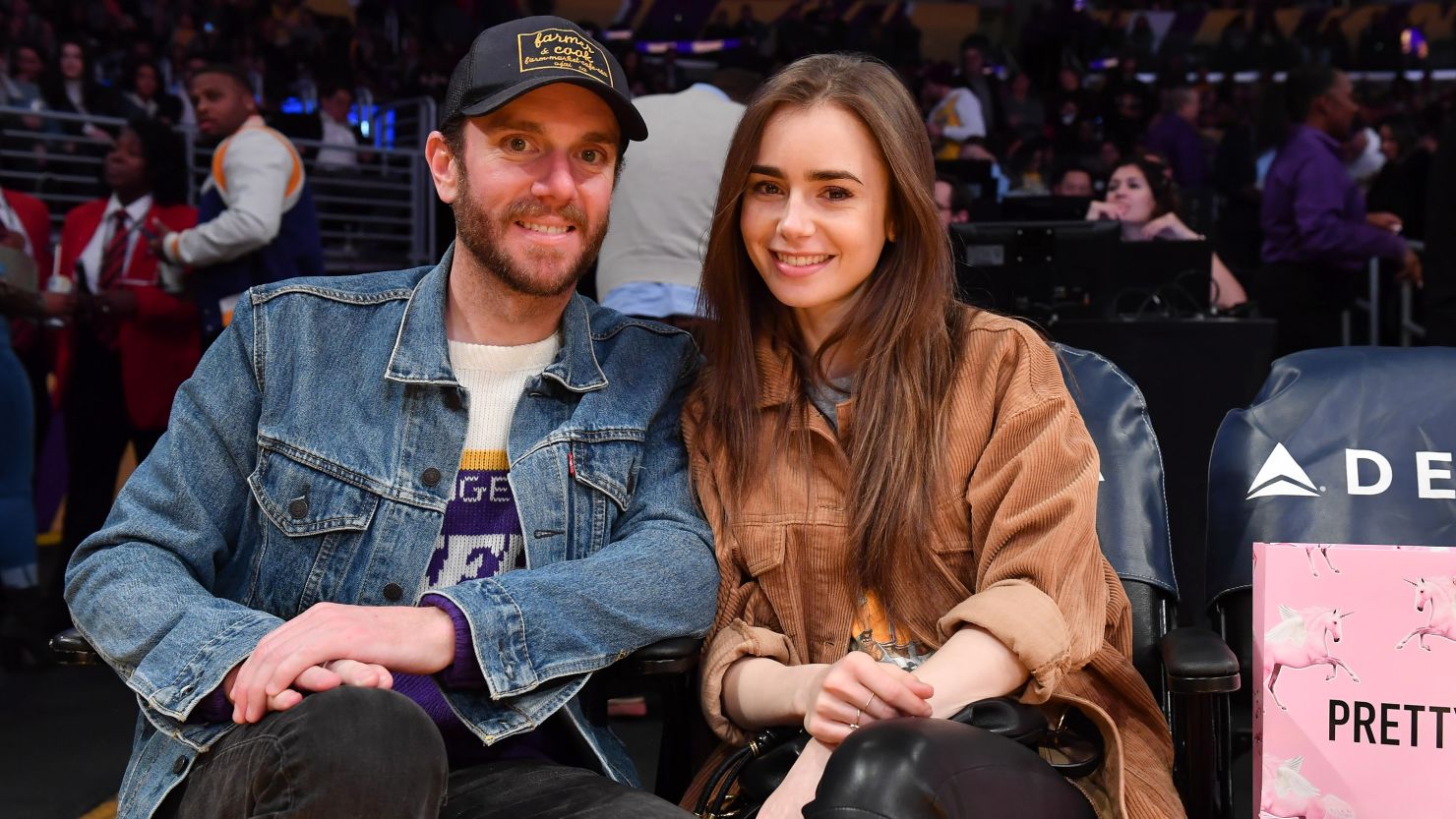 Lily Collins and Charlie McDowell, together here at a basketball game in 2020, got married over the weekend.
