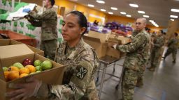 SAN JOSE, CALIFORNIA - MARCH 24: Members of the California National Guard 115th Regional Support Group help pack boxes of fruit and other food at the Second Harvest Food Bank of Silicon Valley on March 24, 2020 in San Jose, California. California Gov. Gavin Newsom has deployed the California National Guard to help distribute food at food banks across the state that have seen a huge decline in volunteers that usually help sort and pack food for the needy. (Photo by Justin Sullivan/Getty Images)