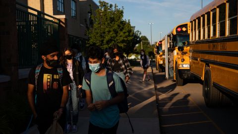 Students arrive at a high school during the first day of classes in Novi, Michigan, on Tuesday.