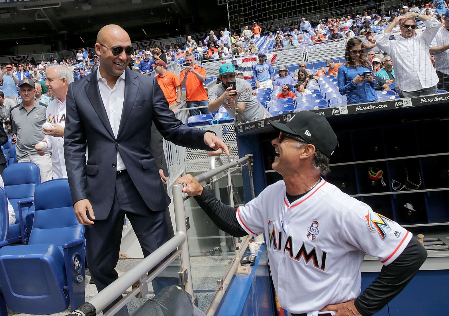 Jeter talks to Marlins manager Don Mattingly during the team's home opener in 2018.