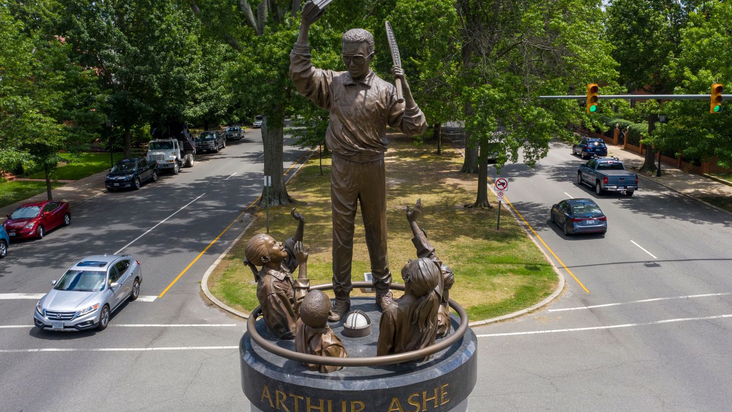 Traffic passes by the statue of tennis star Arthur Ashe on Monument Avenue. He died in 1993.