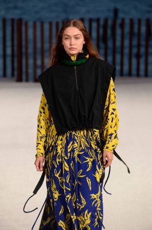 Gigi Hadid walked the runway at Proenza Schouler's show wearing a bright yellow and blue patterned dress paired with a black vest.