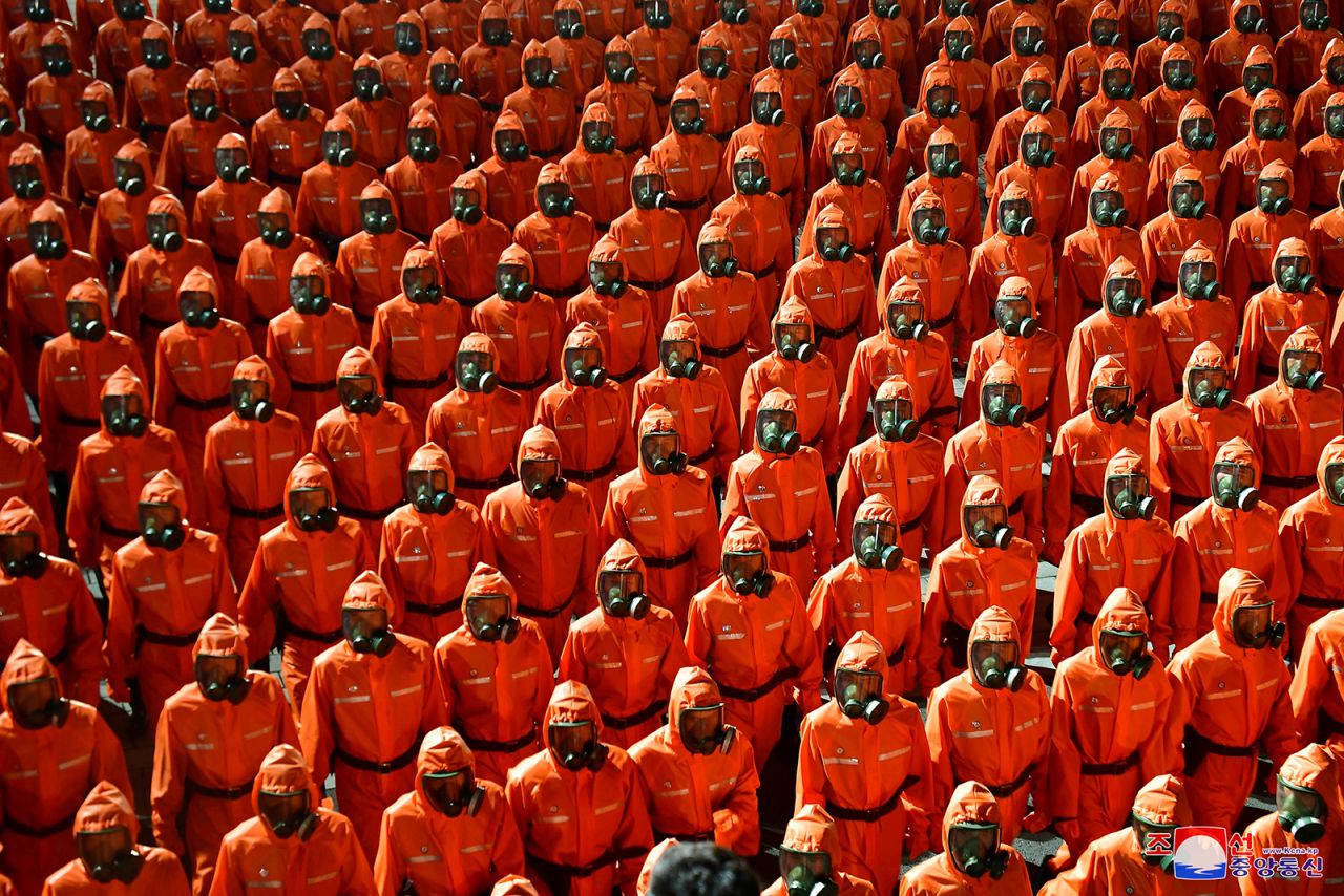 People wearing hazmat-style suits and gas masks march during a <a href="https://www.cnn.com/2021/09/09/asia/north-korea-military-parade-intl-hnk/index.html" target="_blank">midnight military parade</a> in Pyongyang, North Korea, in this image supplied Thursday, September 9, by North Korea's state-run news agency. The agency reported that the parade was held to mark the 73rd anniversary of the country's founding.