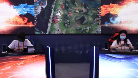 Visitors playing "Arena of Valor," a multiplayer online battle arena game, at Tencent's booth during a trade fair in September in Beijing.