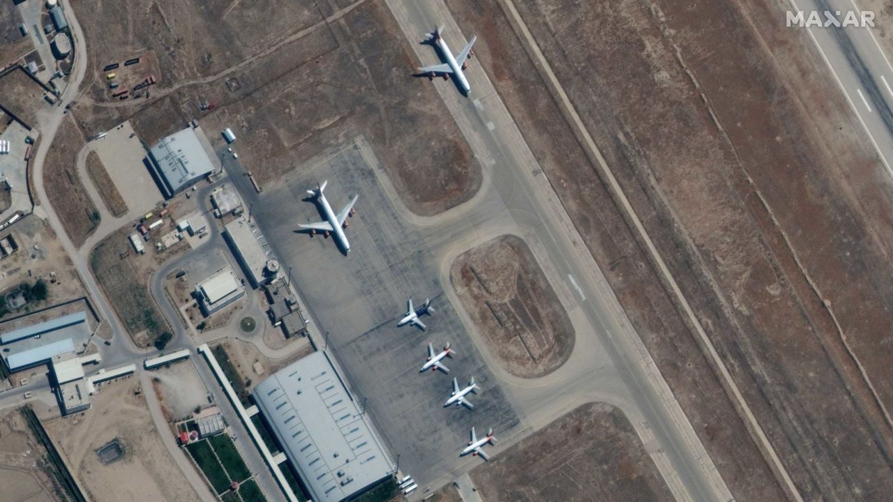 A handout satellite image made available by Maxar Technologies shows airplanes near the main terminal at Mazar-i-Sharif Airport, northern Afghanistan, on September 3, 2021.
