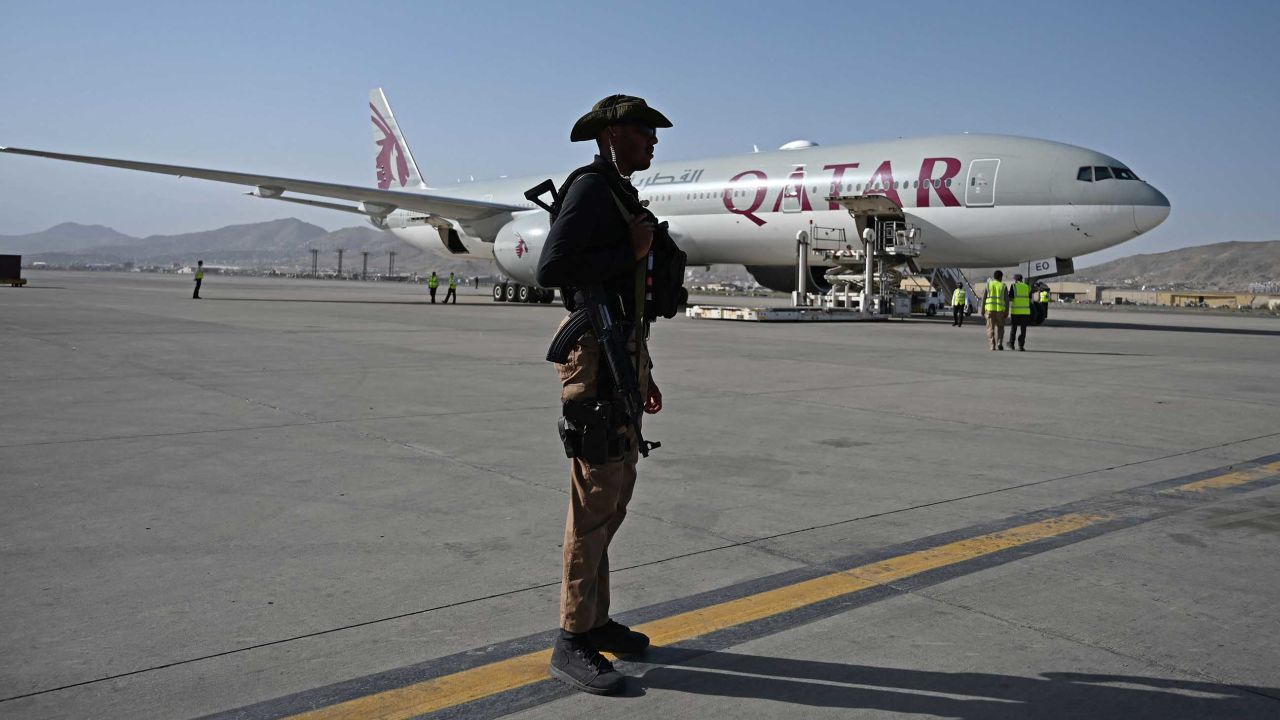 A Qatari security personnel member stands guard near a Qatar Airways aircraft at the airport in Kabul on Thursday.