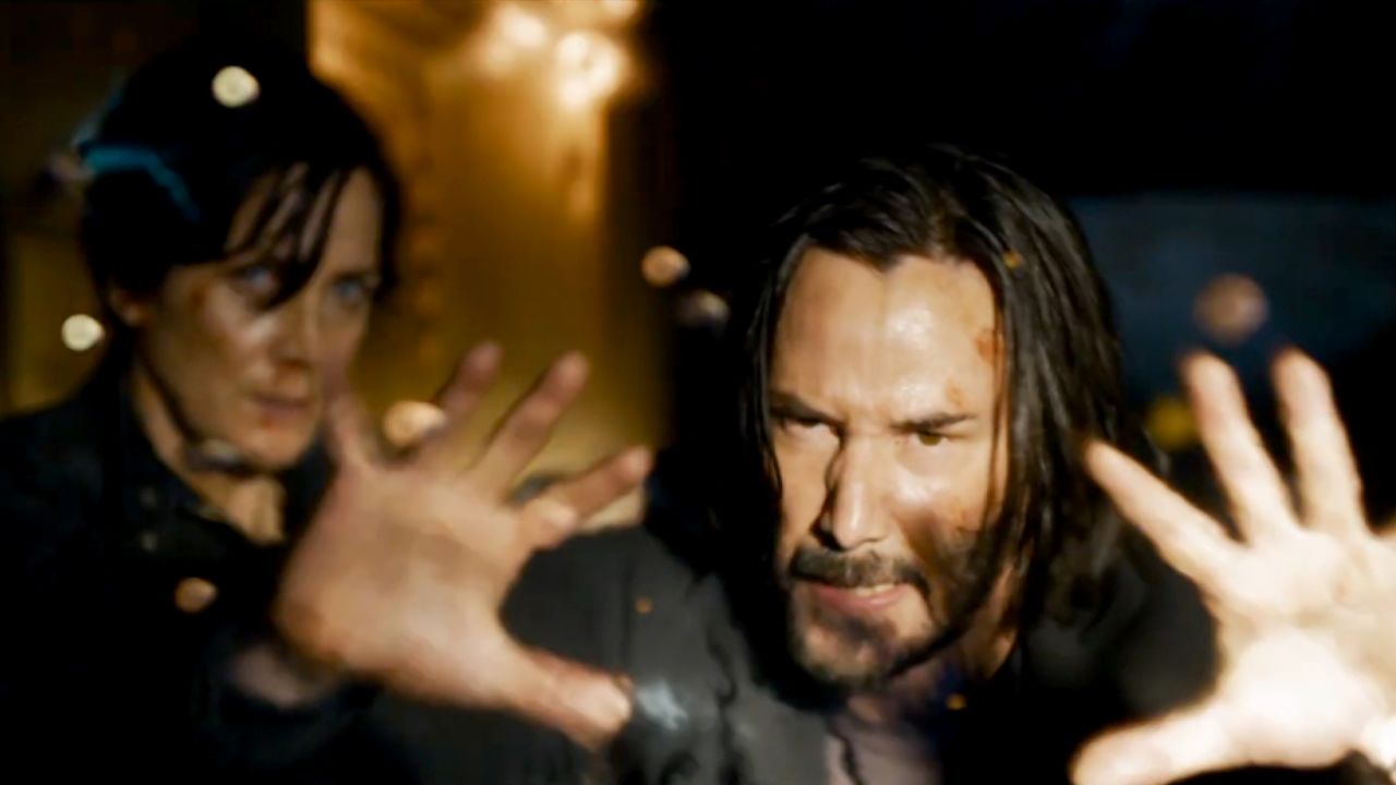 Keanu Reeves as Neo (right) and Carrie-Ann Moss as Trinity (left) are back in "The Matrix Resurrections."