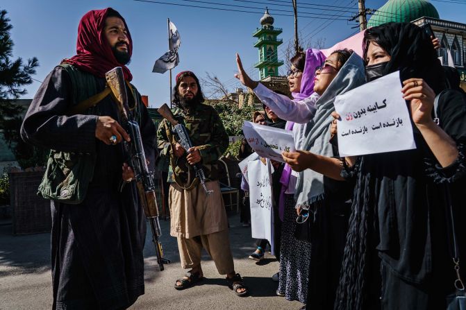 Taliban fighters try to stop the advance of <a href="index.php?page=&url=http%3A%2F%2Fwww.cnn.com%2F2021%2F09%2F08%2Fasia%2Fafghanistan-women-taliban-government-intl%2Findex.html" target="_blank">female protesters</a> marching through Kabul, Afghanistan, on Wednesday, September 8. It was a day after the Taliban announced an all-male interim government with no representation for women or ethnic minority groups.