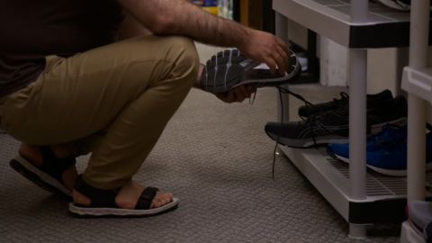 AA is seen at the food bank picking up shoes for his family.