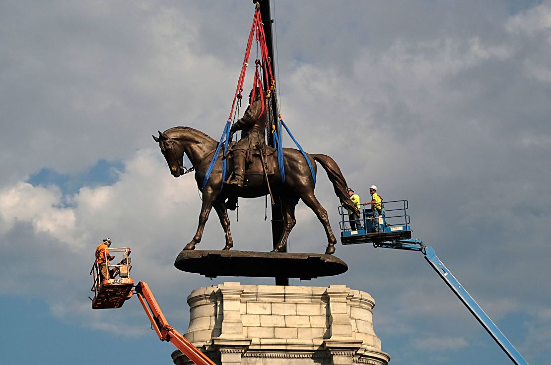 The statue of Confederate General Robert E. Lee is removed from its pedestal on Monument Avenue on September 8, 2021 in Richmond, Virginia. 