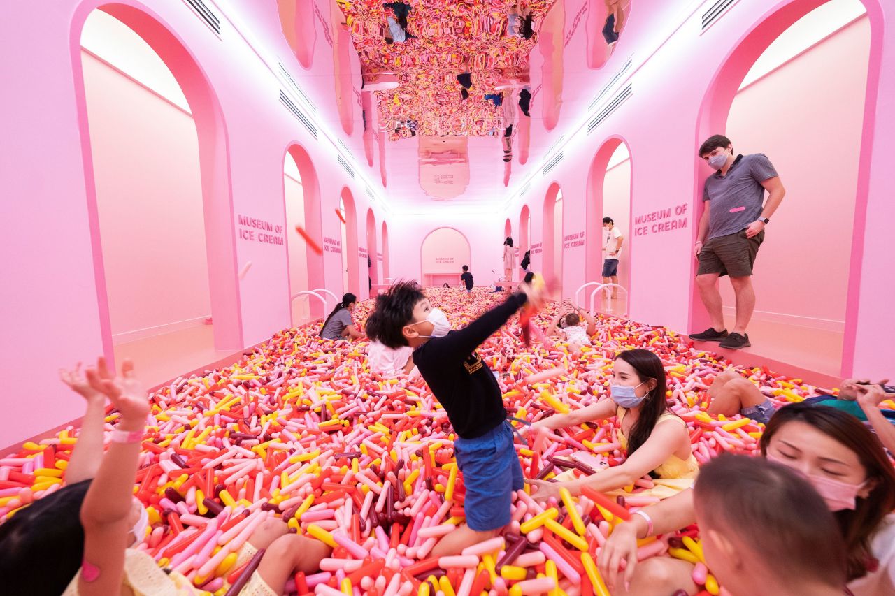 People play in the "Sprinkle Pool" installation at the Museum of Ice Cream in Singapore on Friday, September 3.