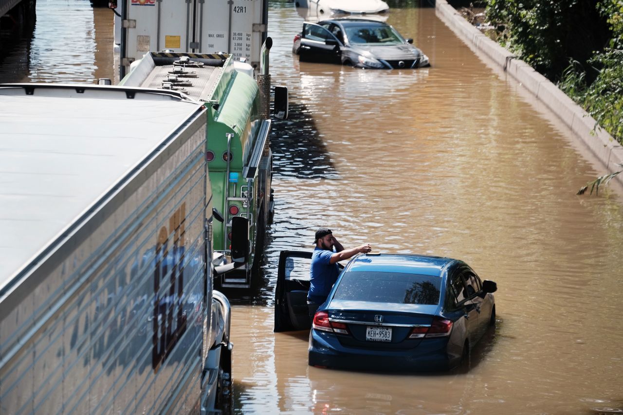 A man stands next to a car on the flooded Major Deegan Expressway in New York City on Thursday, September 2. Torrential rain from Hurricane Ida's remnants caused <a href="https://www.cnn.com/2021/09/02/weather/gallery/ida-flooding-tornado-northeast/index.html" target="_blank">deadly flooding</a> in parts of the Northeast and the Mid-Atlantic as the storm made its way up the East Coast. Emergencies were declared for New York state, New York City and New Jersey.