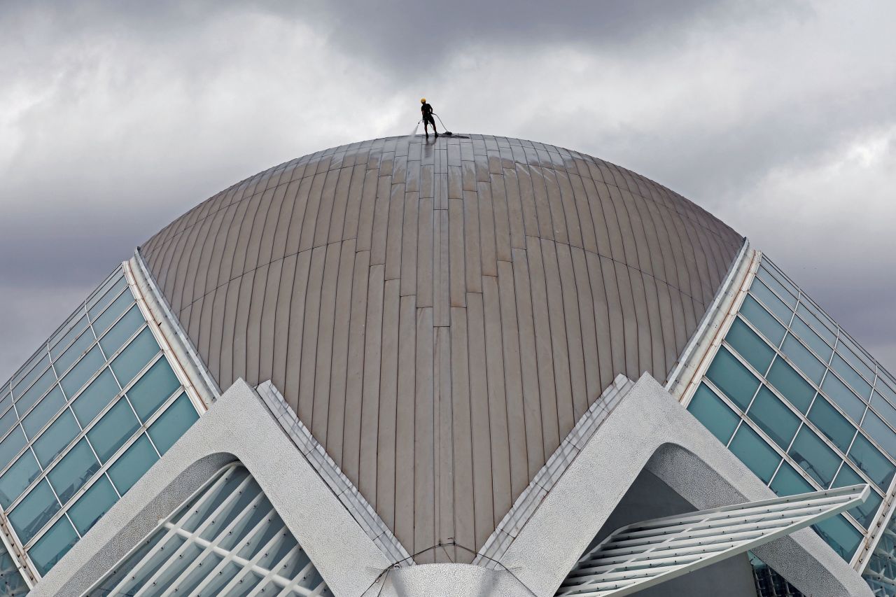A worker cleans the dome of the Hemisfèric at the City of Arts and Sciences in Valencia, Spain, on Tuesday, September 7.