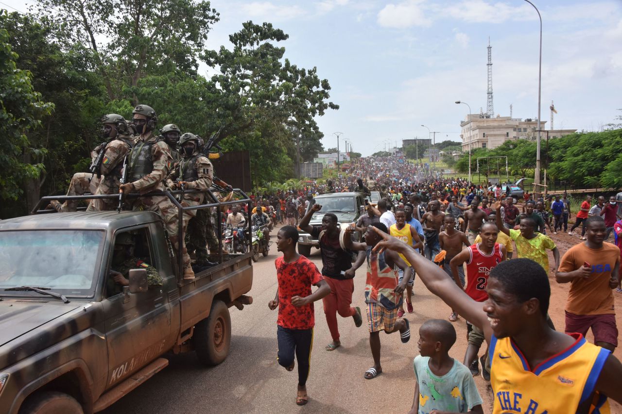People celebrate in the streets with members of Guinea's armed forces after the country's President, Alpha Conde, was arrested during <a href="https://www.cnn.com/2021/09/05/africa/guinea-coup-intl/index.html" target="_blank">a coup</a> on Sunday, September 5.
