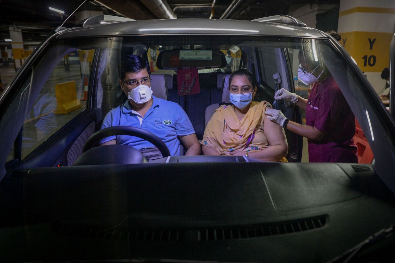 A health-care worker administers a Covid-19 vaccine at a drive-through in Vashi, India, on Wednesday, September 8.