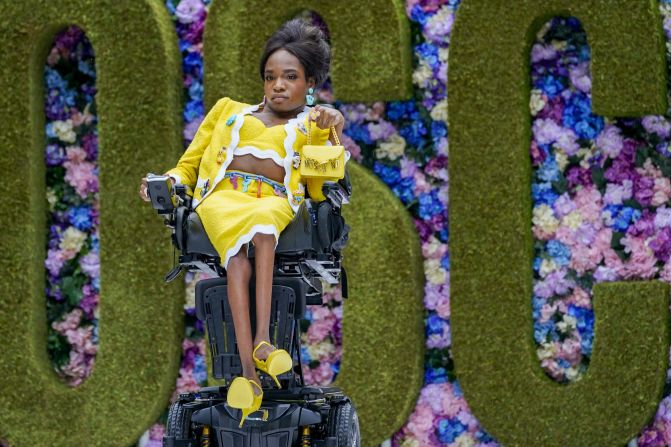 Disabled transgender model Aaron Philip featured in Moschino's show, wearing a yellow skirt suit.