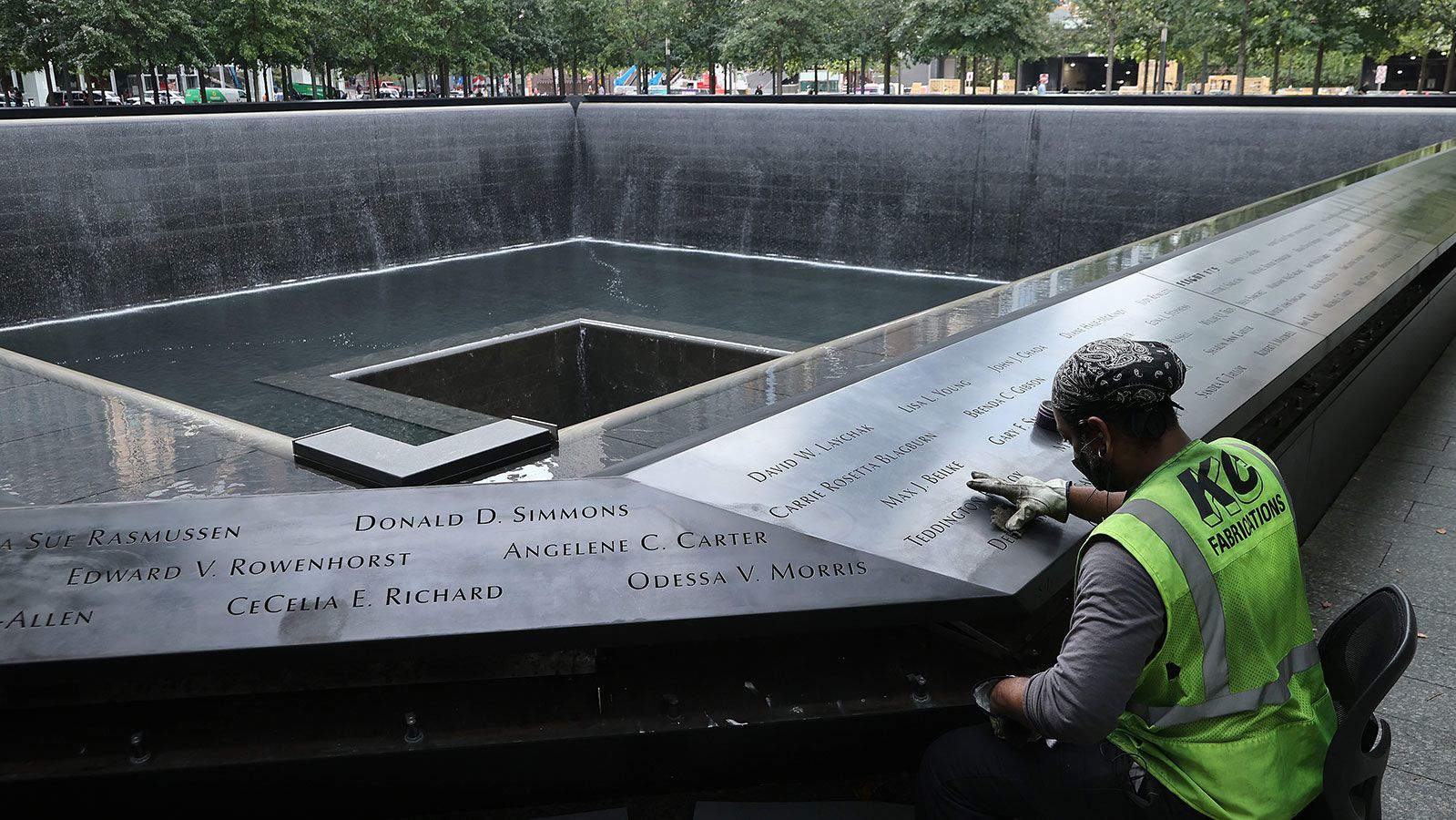 Polishing work is done on the bronze parapets surrounding the twin Memorial pools where the names of the 2,983 names of the men, women, and children killed in the attacks of September 11, 2001 and February 26, 1993 are inscribed at the 9/11 Memorial and Museum on September 8, 2021 in New York City. 
