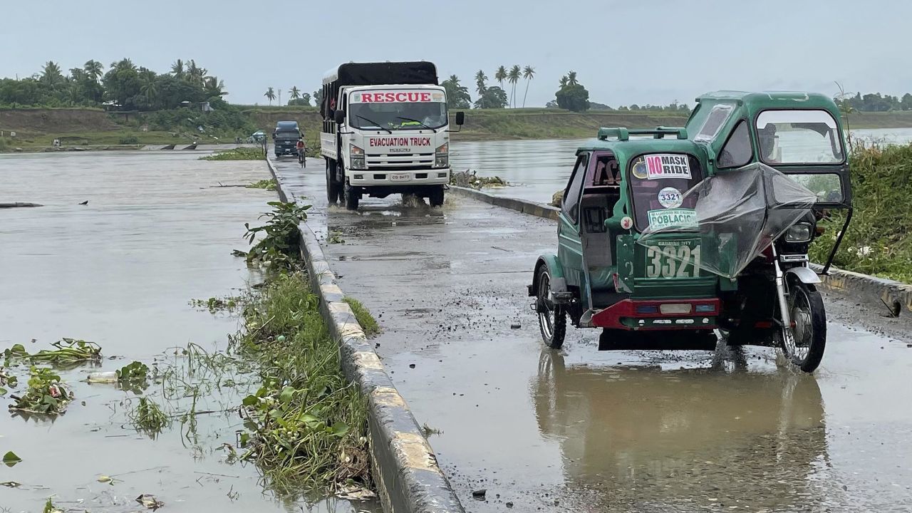 Motorists cross a bridge as the river starts to swell due to approaching Super Typhoon Chanthu in Cauayan, Isabela province, northern Philippines, on September 10.